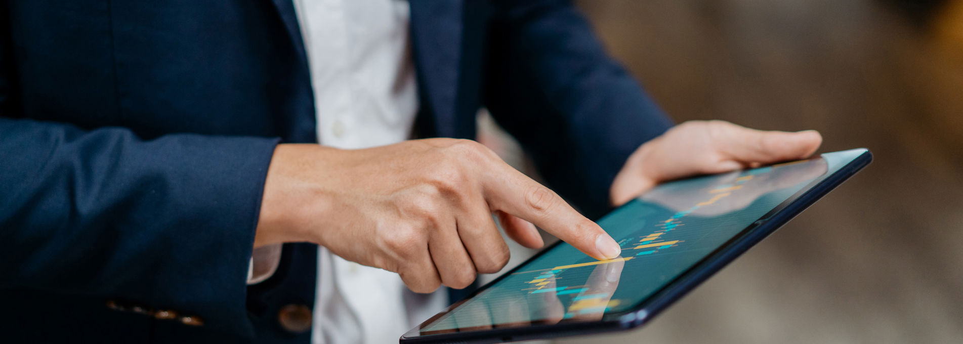 Manager reviewing workforce management data on a tablet with real-time insights into scheduling, staffing levels and time tracking